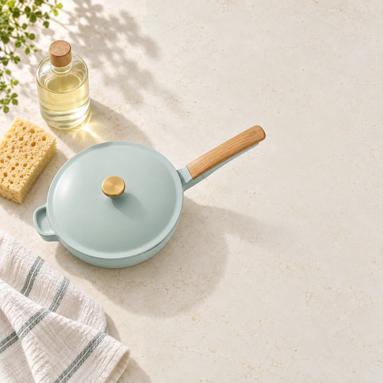 Mini pan with soft sponge and towel on a stone counter
